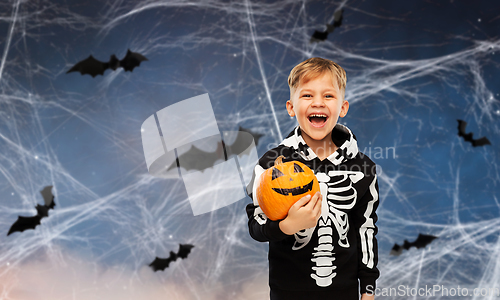 Image of happy boy in halloween costume with jack-o-lantern