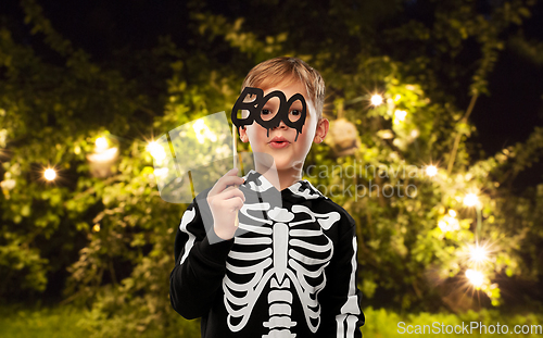 Image of boy in halloween costume of skeleton making faces