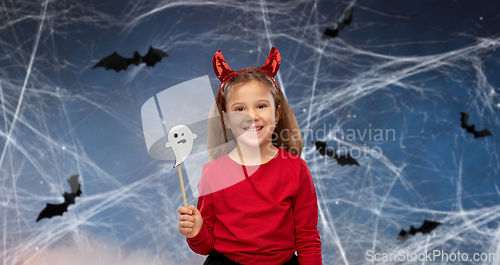 Image of girl in halloween costume with ghost party prop