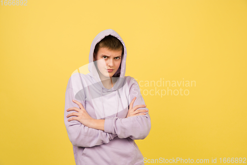 Image of Caucasian girl\'s portrait isolated on yellow studio background with copyspace