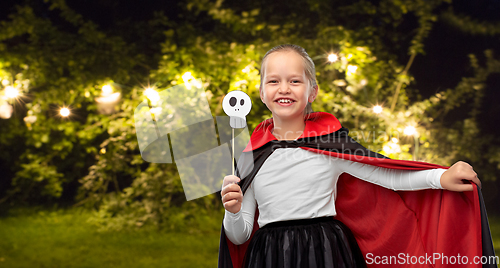 Image of girl in costume of dracula with cape on halloween