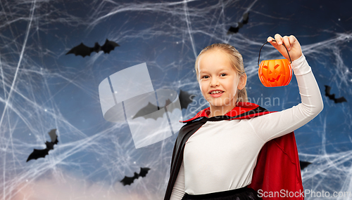 Image of girl in halloween costume of dracula with pumpkin