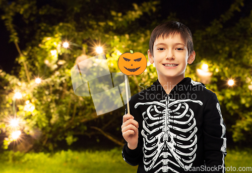 Image of boy in halloween costume of skeleton with pumpkin