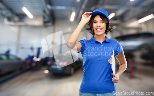 Image of female worker with clipboard at car service