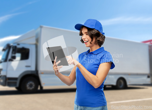 Image of happy smiling delivery girl with tablet computer