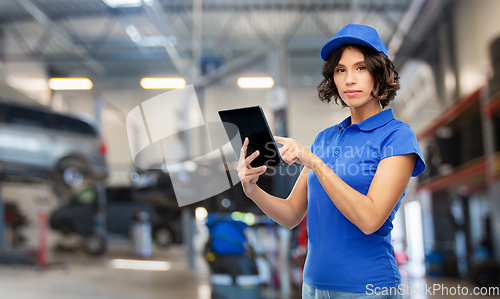 Image of female worker with tablet pc at car service