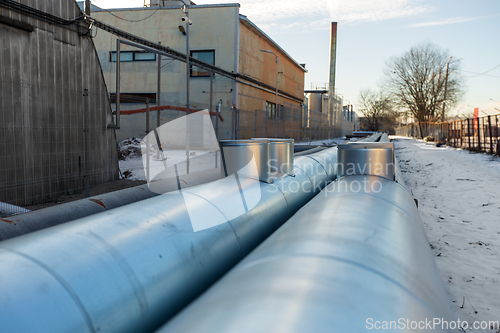 Image of outdoor pipeline and old hangar in winter