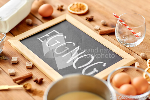 Image of eggnog word on chalkboard, ingredients and spices