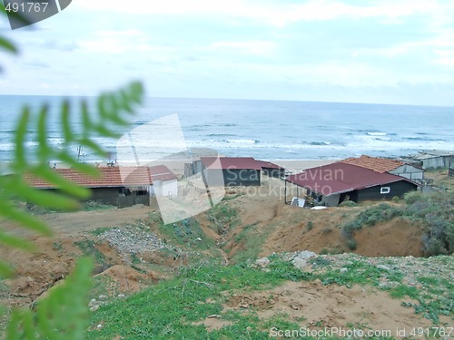 Image of old shacks by the beach
