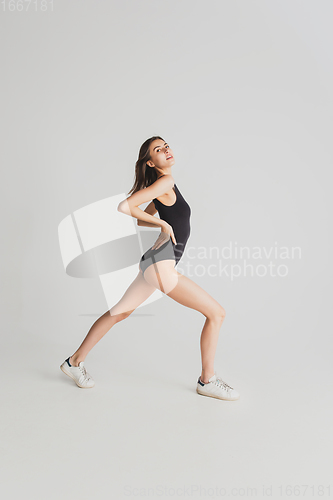 Image of Beautiful young woman\'s portrait isolated on white studio background. Having fun, happy, full length