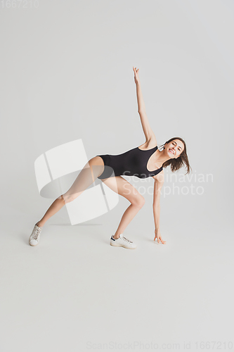 Image of Beautiful young woman\'s portrait isolated on white studio background. Having fun, happy, full length