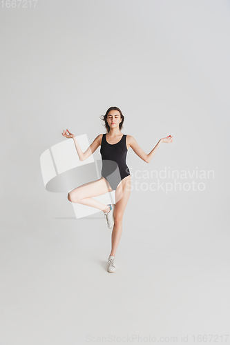 Image of Beautiful young woman\'s portrait isolated on white studio background. Having fun, happy, full length