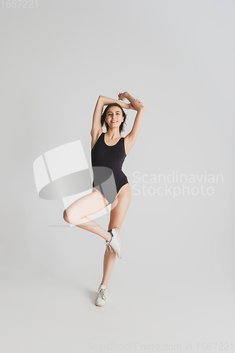 Image of Beautiful young woman\'s portrait isolated on white studio background. Having fun, happy, full length