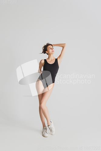 Image of Beautiful young woman\'s portrait isolated on white studio background. Having fun, happy, full length