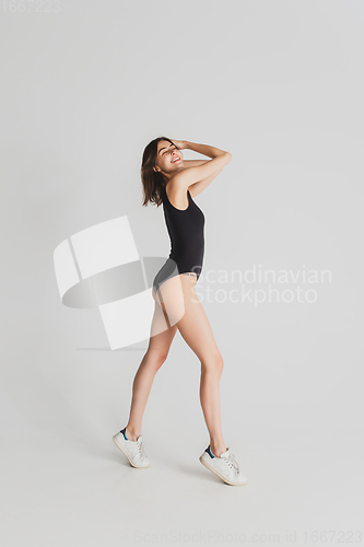 Image of Beautiful young woman\'s portrait isolated on white studio background. Having fun, happy, full length