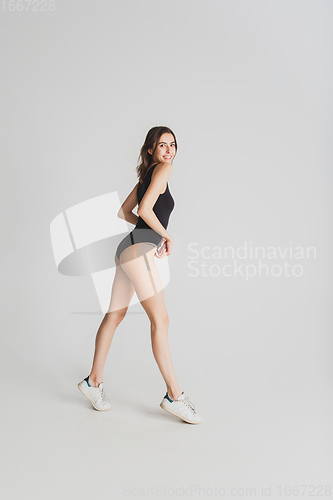 Image of Beautiful young woman\'s portrait isolated on white studio background. Having fun, happy, full length