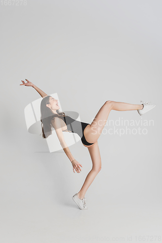 Image of Beautiful young woman\'s portrait isolated on white studio background. Having fun, happy, full length