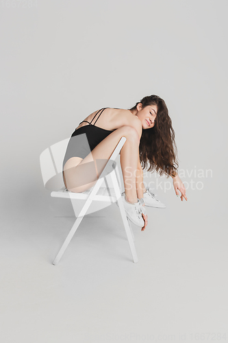Image of Beautiful young woman\'s portrait isolated on white studio background. Having fun, happy, full length