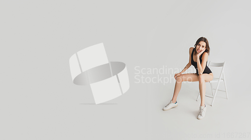 Image of Beautiful young woman\'s portrait isolated on white studio background. Having fun, happy, full length