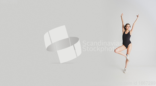 Image of Beautiful young woman\'s portrait isolated on white studio background. Having fun, happy, full length