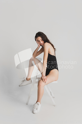 Image of Beautiful young woman\'s portrait isolated on white studio background. Having fun, happy, full length