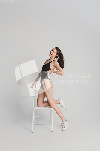 Image of Beautiful young woman\'s portrait isolated on white studio background. Having fun, happy, full length
