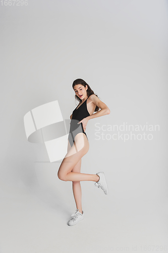 Image of Beautiful young woman\'s portrait isolated on white studio background. Having fun, happy, full length
