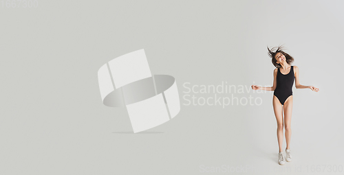 Image of Beautiful young woman\'s portrait isolated on white studio background. Having fun, happy, full length