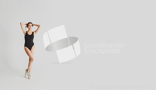 Image of Beautiful young woman\'s portrait isolated on white studio background. Having fun, happy, full length
