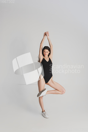 Image of Beautiful young woman\'s portrait isolated on white studio background. Having fun, happy, full length