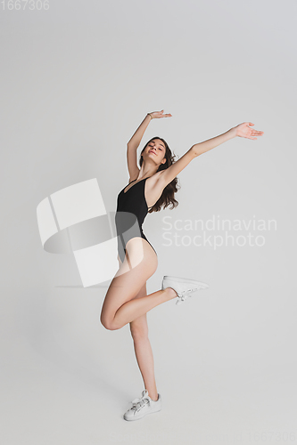 Image of Beautiful young woman\'s portrait isolated on white studio background. Having fun, happy, full length