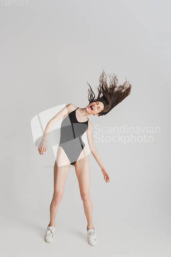 Image of Beautiful young woman\'s portrait isolated on white studio background. Having fun, happy, full length