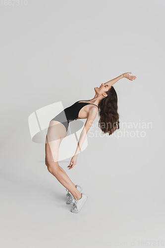 Image of Beautiful young woman\'s portrait isolated on white studio background. Having fun, happy, full length