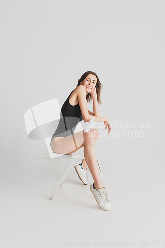 Image of Beautiful young woman\'s portrait isolated on white studio background. Having fun, happy, full length