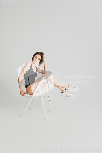 Image of Beautiful young woman\'s portrait isolated on white studio background. Having fun, happy, full length