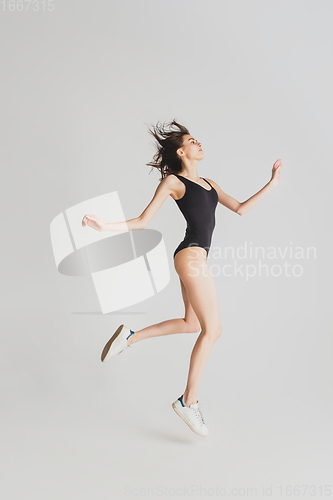 Image of Beautiful young woman\'s portrait isolated on white studio background. Having fun, happy, full length