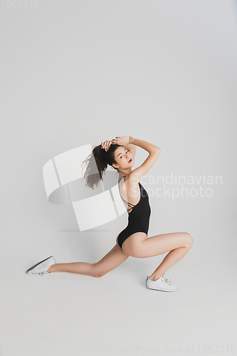 Image of Beautiful young woman\'s portrait isolated on white studio background. Having fun, happy, full length