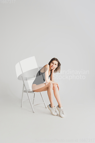 Image of Beautiful young woman\'s portrait isolated on white studio background. Having fun, happy, full length