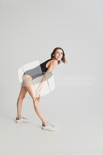 Image of Beautiful young woman\'s portrait isolated on white studio background. Having fun, happy, full length
