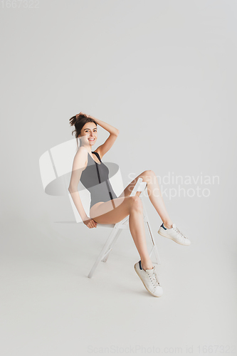 Image of Beautiful young woman\'s portrait isolated on white studio background. Having fun, happy, full length