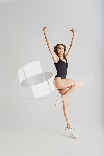 Image of Beautiful young woman\'s portrait isolated on white studio background. Having fun, happy, full length