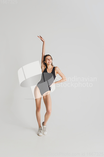 Image of Beautiful young woman\'s portrait isolated on white studio background. Having fun, happy, full length