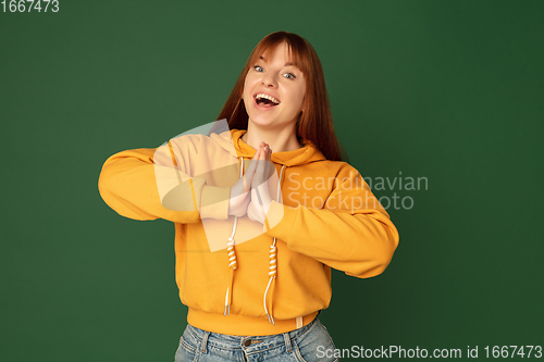 Image of Caucasian woman\'s portrait isolated on green studio background with copyspace