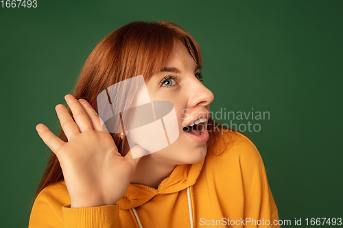 Image of Caucasian woman\'s portrait isolated on green studio background with copyspace