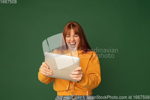 Image of Caucasian woman\'s portrait isolated on green studio background with copyspace
