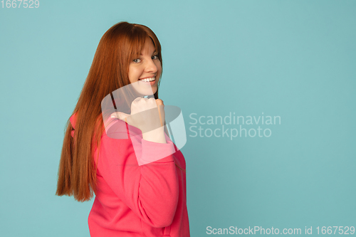 Image of Caucasian woman\'s portrait isolated on blue studio background with copyspace