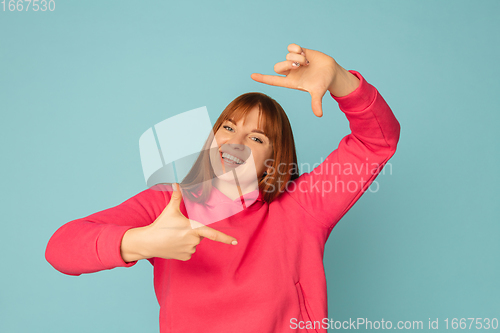 Image of Caucasian woman\'s portrait isolated on blue studio background with copyspace