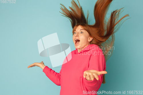 Image of Caucasian woman\'s portrait isolated on blue studio background with copyspace