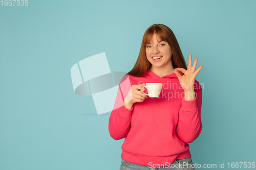 Image of Caucasian woman\'s portrait isolated on blue studio background with copyspace