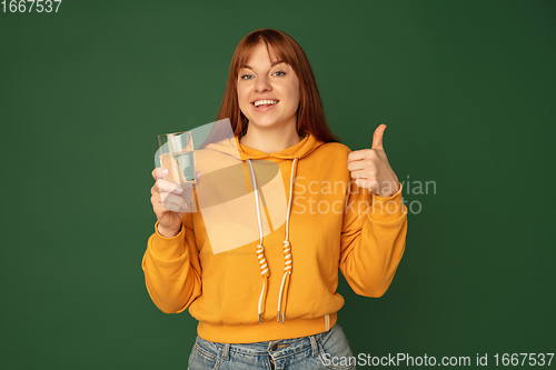 Image of Caucasian woman\'s portrait isolated on green studio background with copyspace